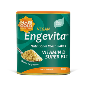 Marigold Engevita nutritional yeast flakes canister with a spoonful of flakes.