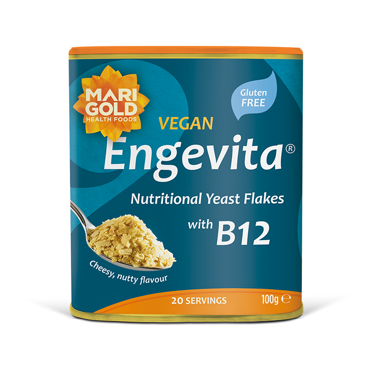 Marigold Engevita nutritional yeast flakes canister with B12 on a solid black background.