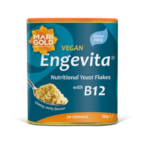 Marigold Engevita nutritional yeast flakes canister with B12 on a solid black background.