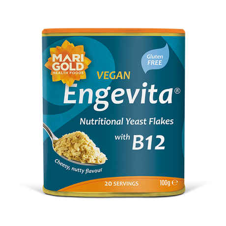Marigold Engevita nutritional yeast flakes canister with B12 on a solid black background.