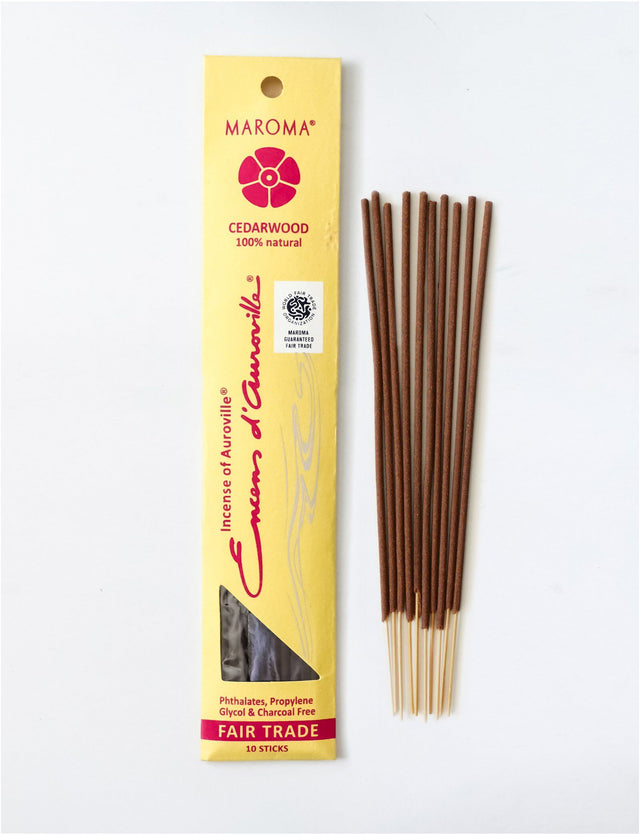 Maroma Cedarwood incense sticks displayed next to their yellow Fair Trade packaging on white.