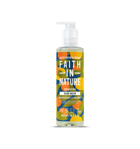 Brightly colored bottle of "Faith in Nature" hand wash with a pump, featuring bold text and abstract floral patterns. Grapefruit and orange scent.