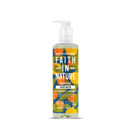 Brightly colored bottle of "Faith in Nature" hand wash with a pump, featuring bold text and abstract floral patterns. Grapefruit and orange scent.