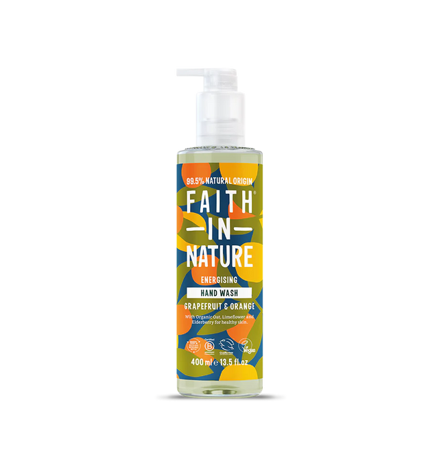 Brightly colored bottle of "Faith in Nature" hand wash with a pump, featuring bold text and abstract floral patterns. Grapefruit and orange scent.