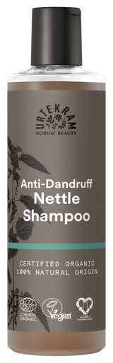 A tall bottle of Urtekram Anti-Dandruff Nettle Shampoo with a grey and brown label featuring a nettle leaf illustration. The bottle displays "Certified Organic" and "100% Natural Origin" labels alongside Vegan and Ecocert certifications.