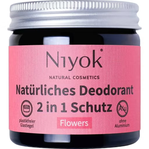 Niyok natural deodorant jar in a "Flowers" scent with a pink label and silver screw cap.