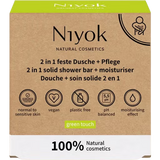 Niyok 2 in 1 solid shower bar and moisturiser box in "green touch" with a cardboard aesthetic.