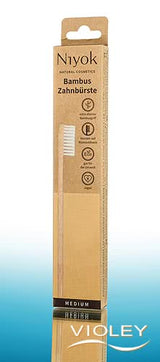 Niyok natural bamboo toothbrush in sustainable brown and yellow eco-friendly cardboard packaging.