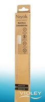 Niyok natural bamboo toothbrush in sustainable brown and yellow eco-friendly cardboard packaging.