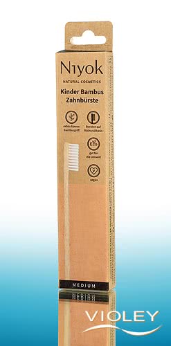 Niyok kids natural bamboo toothbrush in sustainable brown and peach cardboard packaging.