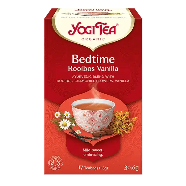 A red box of Yogi Tea Organic Bedtime Rooibos Vanilla featuring an Ayurvedic blend with chamomile flowers and vanilla beans on a white background.