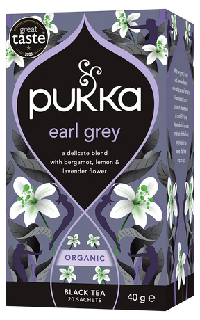A purple box of Pukka Organic Earl Grey black tea, featuring a delicate blend with bergamot, lemon, and lavender flower containing 20 sachets.