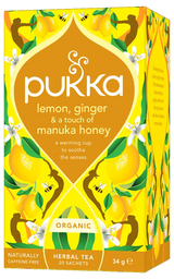 A vibrant yellow box of Pukka Organic Lemon, Ginger & Manuka Honey herbal tea, featuring a warming caffeine-free blend to soothe the senses containing 20 sachets.