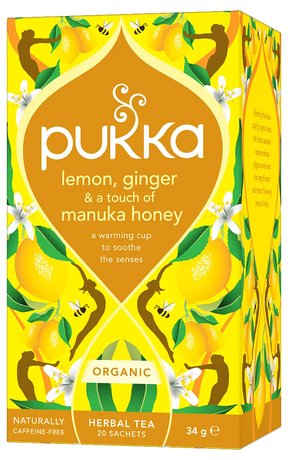 A vibrant yellow box of Pukka Organic Lemon, Ginger & Manuka Honey herbal tea, featuring a warming caffeine-free blend to soothe the senses containing 20 sachets.