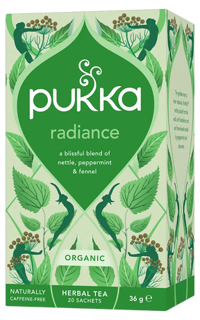 A light green box of Pukka Organic Radiance herbal tea, featuring a caffeine-free, blissful blend of nettle, peppermint, and fennel containing 20 sachets.