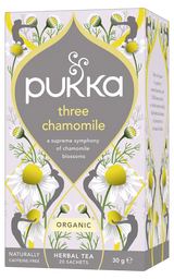 A light purple box of Pukka Organic Three Chamomile herbal tea, featuring a caffeine-free blend of chamomile blossoms containing 20 sachets.