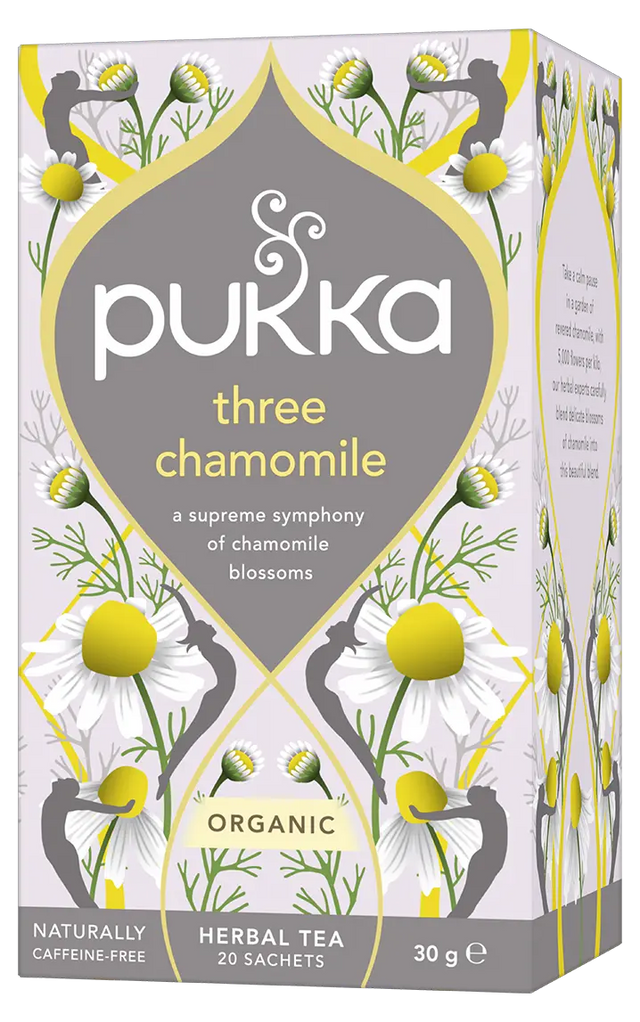A light purple box of Pukka Organic Three Chamomile herbal tea, featuring a caffeine-free blend of chamomile blossoms containing 20 sachets.