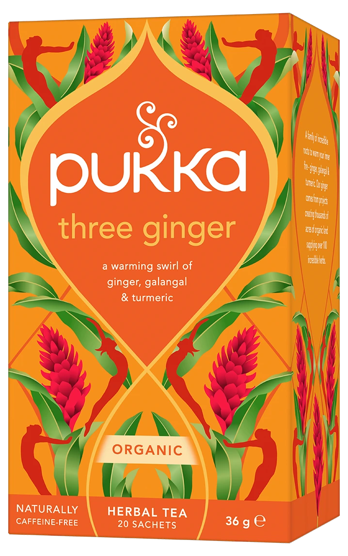 An orange box of Pukka Organic Three Ginger herbal tea, featuring a warming caffeine-free blend of ginger, galangal, and turmeric containing 20 sachets.