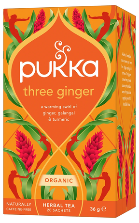 An orange box of Pukka Organic Three Ginger herbal tea, featuring a warming caffeine-free blend of ginger, galangal, and turmeric containing 20 sachets.