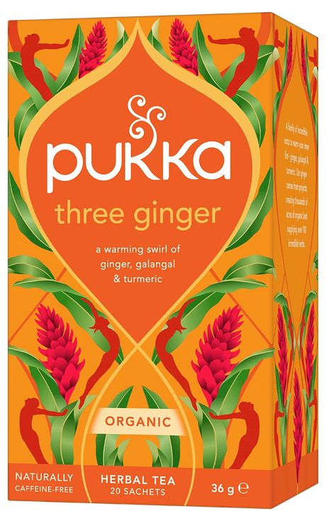 An orange box of Pukka Organic Three Ginger herbal tea, featuring a warming caffeine-free blend of ginger, galangal, and turmeric containing 20 sachets.