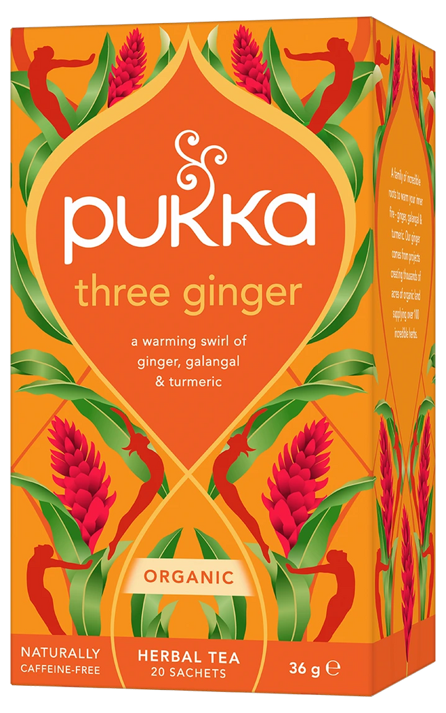 An orange box of Pukka Organic Three Ginger herbal tea, featuring a warming caffeine-free blend of ginger, galangal, and turmeric containing 20 sachets.