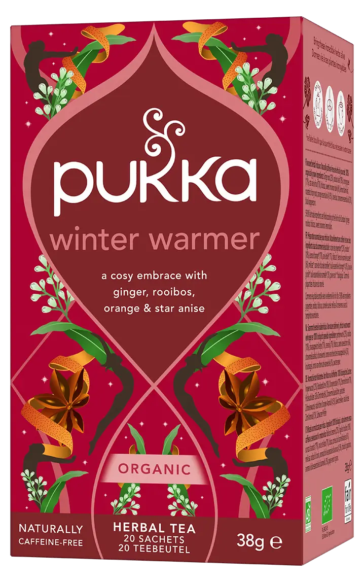 A red box of Pukka Organic Winter Warmer herbal tea, a caffeine-free blend of ginger, rooibos, orange, and star anise containing 20 sachets.