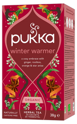 A red box of Pukka Organic Winter Warmer herbal tea, a caffeine-free blend of ginger, rooibos, orange, and star anise containing 20 sachets.