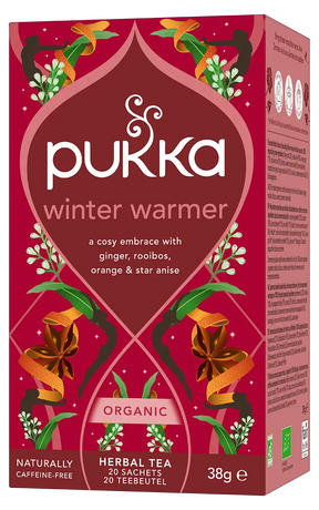 A red box of Pukka Organic Winter Warmer herbal tea, a caffeine-free blend of ginger, rooibos, orange, and star anise containing 20 sachets.