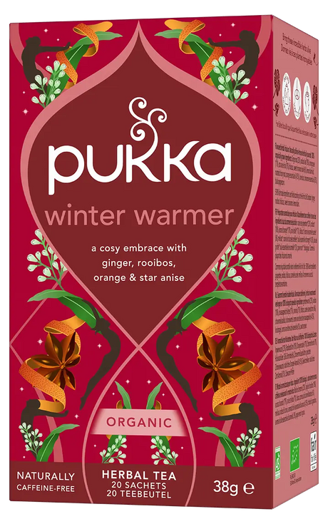 A red box of Pukka Organic Winter Warmer herbal tea, a caffeine-free blend of ginger, rooibos, orange, and star anise containing 20 sachets.