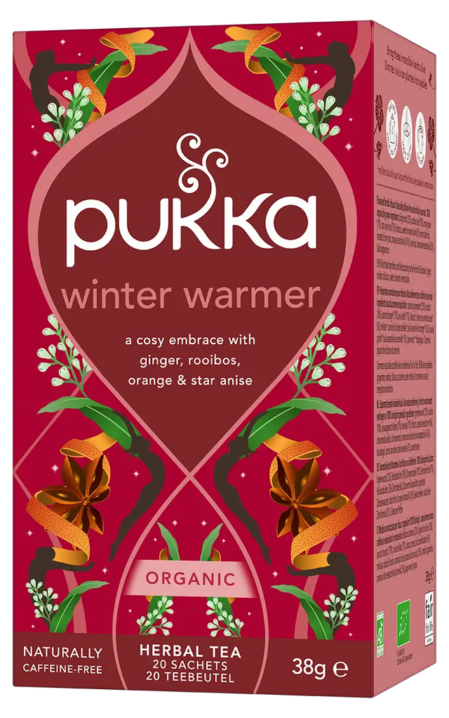 A red box of Pukka Organic Winter Warmer herbal tea, a caffeine-free blend of ginger, rooibos, orange, and star anise containing 20 sachets.