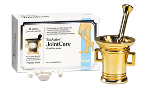 BioActive JointCare supplement packaging box with loose white tablets in front, shown beside a decorative gold mortar and pestle on a white background.