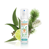 Puressentiel purifying air spray bottle surrounded by eucalyptus leaves, lime, and pine.