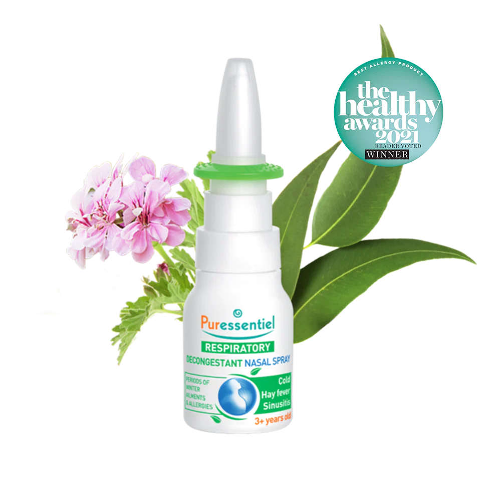 Puressentiel Resp OK decongestant nasal spray with eucalyptus leaves, a small purple flower, and water splashes.