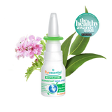 Puressentiel Resp OK decongestant nasal spray with eucalyptus leaves, a small purple flower, and water splashes.