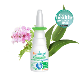 Puressentiel Resp OK decongestant nasal spray with eucalyptus leaves, a small purple flower, and water splashes.
