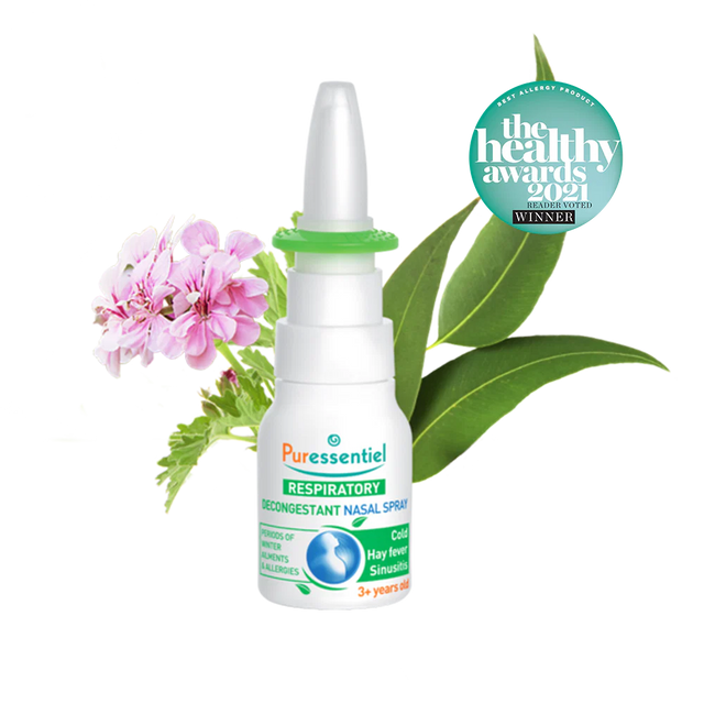 Puressentiel Resp OK decongestant nasal spray with eucalyptus leaves, a small purple flower, and water splashes.