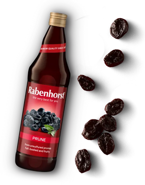 Glass bottle of Rabenhorst Prune juice with a red label, accompanied by scattered dried prunes.