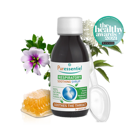 Puressentiel respiratory soothing syrup bottle with honeycomb, a purple flower, and a plastic measuring spoon.