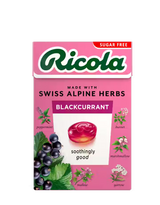Pink sugar-free Ricola Blackcurrant herb drops box with botanical illustrations.
