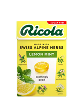 Yellow sugar-free Ricola Lemon Mint herb drops box with botanical illustrations.