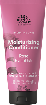 A rose-pink squeeze tube of Urtekram Moisturizing Conditioner for normal hair, featuring a rose illustration and the "Hydrating Care" tagline. The label indicates it contains moisturizing aloe vera and glycerine, is certified organic, 100% natural origin, and holds Vegan and Ecocert COSMOS Organic certifications.