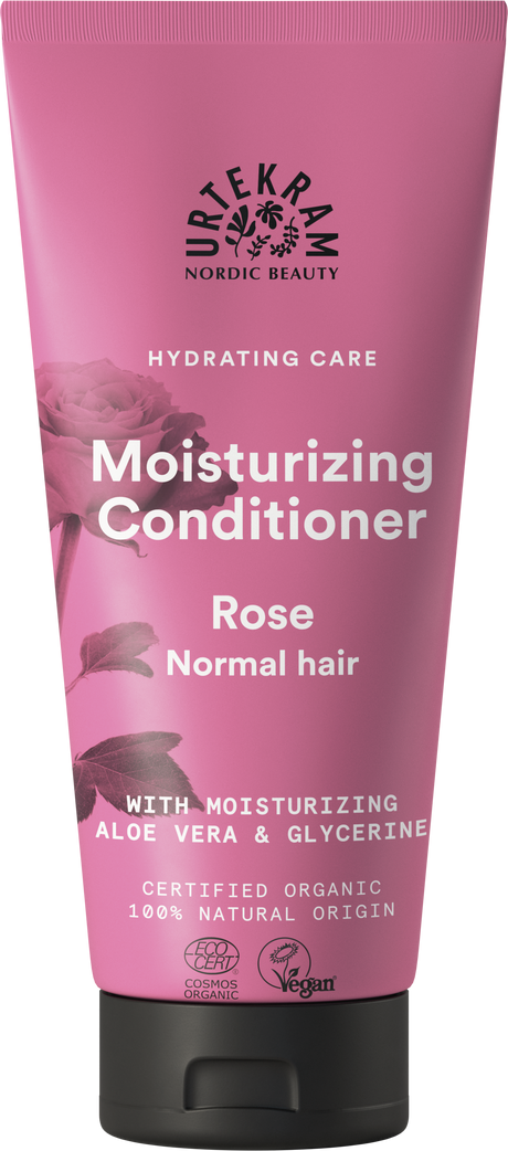 A rose-pink squeeze tube of Urtekram Moisturizing Conditioner for normal hair, featuring a rose illustration and the "Hydrating Care" tagline. The label indicates it contains moisturizing aloe vera and glycerine, is certified organic, 100% natural origin, and holds Vegan and Ecocert COSMOS Organic certifications.