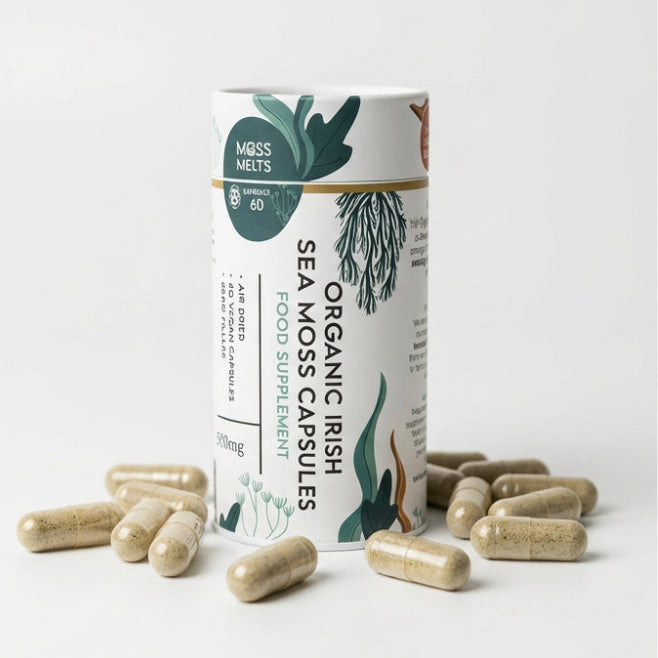 A cylindrical container of Moss Melts Organic Irish Sea Moss Capsules, a food supplement, surrounded by several scattered capsules on a white surface, featuring illustrative seaweed designs.