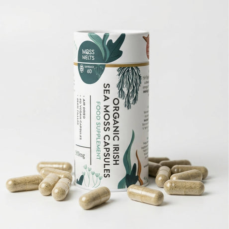 A cylindrical container of Moss Melts Organic Irish Sea Moss Capsules, a food supplement, surrounded by several scattered capsules on a white surface, featuring illustrative seaweed designs.