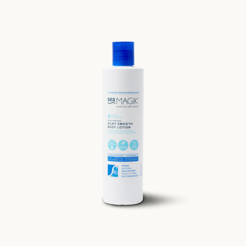 Tall white bottle of Sea Magik Silky Smooth Body Lotion with a blue dispenser cap and label.