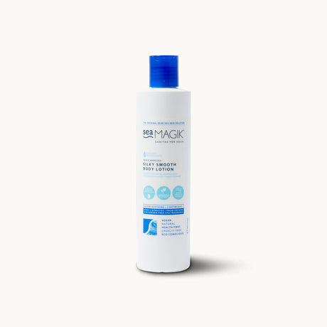 Tall white bottle of Sea Magik Silky Smooth Body Lotion with a blue dispenser cap and label.