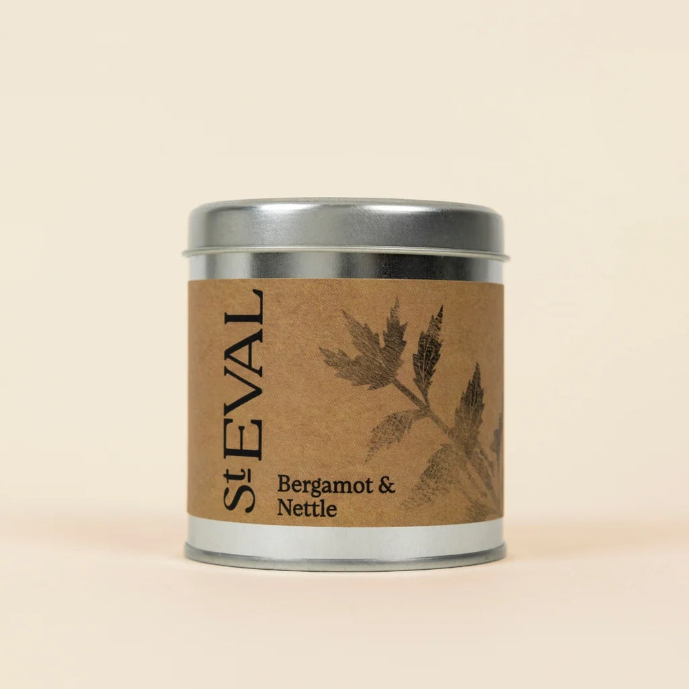 Small silver tin of St Eval Bergamot & Nettle candle featuring a brown kraft paper label.