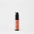 Sukin Brightening Illuminating Moisturiser in a dark amber pump bottle.