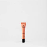 Sukin Brightening Illuminating Eye Gel in a peach tube with black cap.