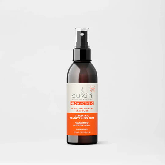 Sukin Glow Active-C Vitamin C Brightening Mist in a dark spray bottle.